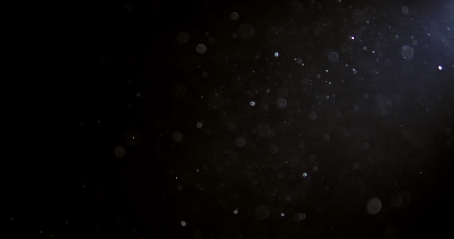 Shot of real dust particles floating in the air. Dust Particles Background. Macro slow motion shot, Use blending mode (screen) 