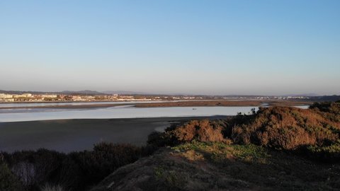 DRONE AERIAL FOOTAGE - The Northern Litoral Natural Park in Ofir, Esposende, Portugal. The Cavado River estuary at sunset.