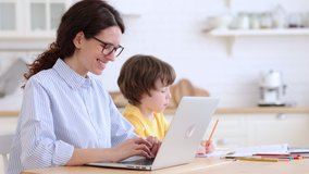 Family, lockdown distance job concept. Kid son painting while his mother is working on laptop at home office. Woman with her child doing homework or studying sitting together at table in living room.  - Powered by Shutterstock - Get 15% off with code: PIKWIZARD15