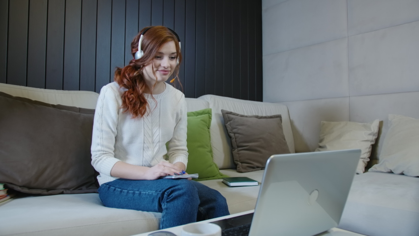 Happy Young Woman Wears Headset Making Distance Online Video Conference Call. Female Internet Teacher Doing Distant Chat Working From Home. Tutoring Write Notes, Teaching Concept Royalty-Free Stock Footage #1070394430
