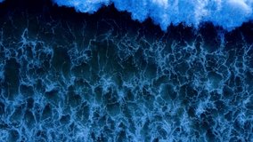 Aerial view Nature video. Powerful stormy sea waves in top-down drone shot perspective. Crashing wave line in Phuket South of Thailand. Andaman sea with foamy white texture. Nature and travel concept.