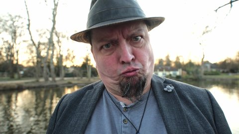 [4k] best age man with goatee doing faces wearing hat