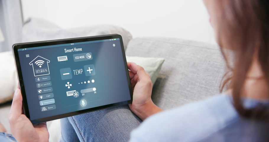 Iot Smart Home Concept - rear view of asian woman ask digital tablet to set temperature of air conditioner more higher by voice at home and all the electric meter in house getting energy-efficient | Shutterstock HD Video #1070401966