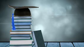 Animation of stack of books with graduation hat on top over glowing lights. education, reading and learning concept digitally generated video.