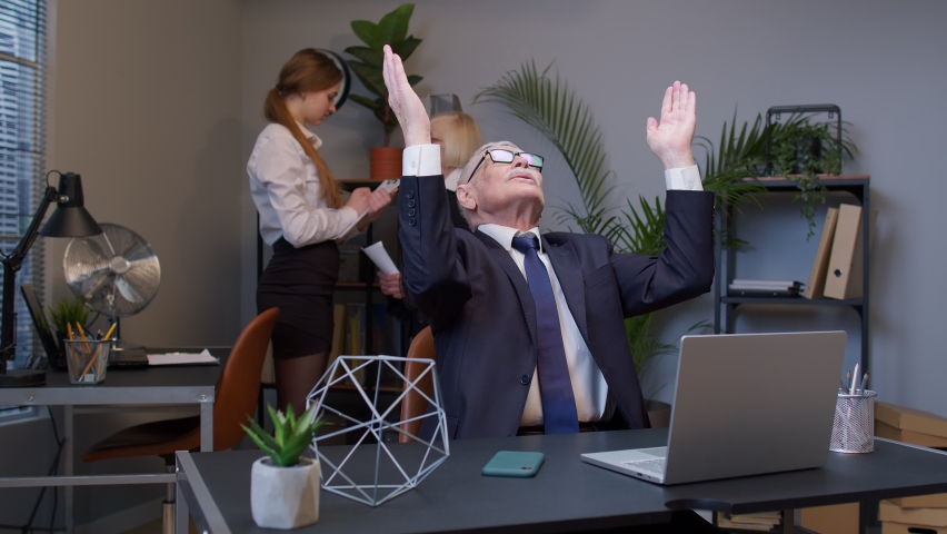 Mature elderly freelancer man praying to God, looking upward and making wish good luck in office. Senior businessman grandfather company director having debt problems, financial crisis, bankruptcy. | Shutterstock HD Video #1070410120