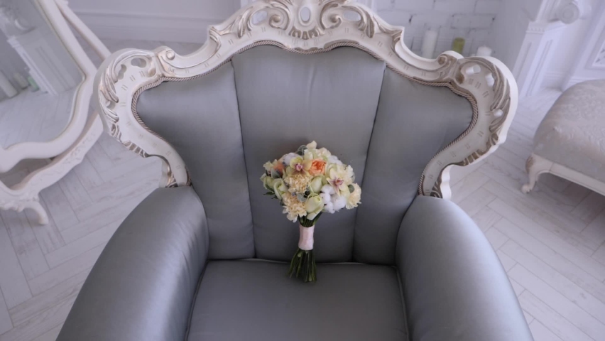 Wedding bouquet with roses on a gray armchair | Shutterstock HD Video #1070412307