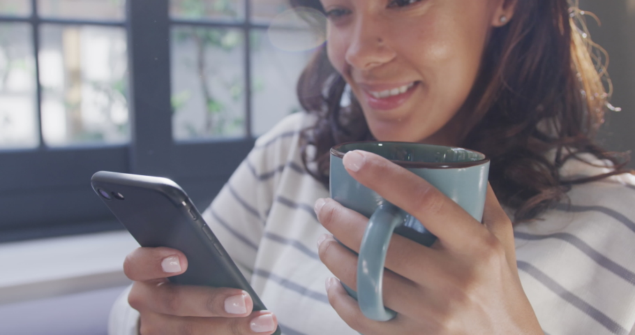 Animation of data processing over woman using smartphone and drinkin tes at home. global connection and digital interface concept digitally generated video.