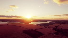 Animation of the word vibes written in white letters with sun setting over lakes and countryside. positive feelings, nature and wellbeing concept, digitally generated video.