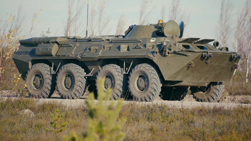 Close-up of an armored personnel carrier of the Russian army riding on the road.