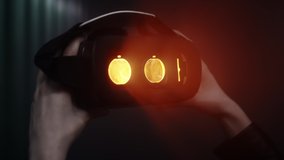 Close-up: A girl puts a virtual reality headset over her eyes. Looks inside the glass of augmented reality glasses. Neon light in the studio. Digital entertainment and arts, immersion - Powered by Shutterstock - Get 15% off with code: PIKWIZARD15
