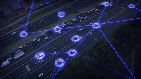 Vehicles connected in a network. Artificial intelligence traffic surveillance system to provide safe driving avoid traffic jams. Aerial view of self driving autonomous cars speeding through highway. 