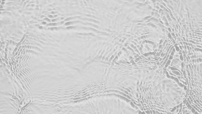 Up close, top view, Slow motion various waves of the water surface hitting the sun's rays, making them sparkle according to different patterns on a gray background video 4K. | Shutterstock HD Video #1070427745