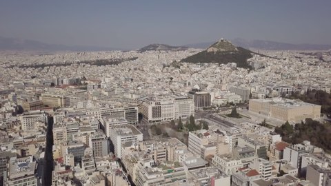 4K footage of a drone flying above Athens near Syntagma square. Parliament and Lycabettus Hill in shot.