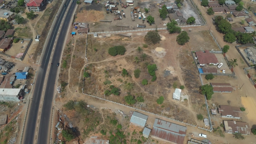 Aerial rural industrial area Freetown Sierra Leone circle. West Africa suffers with extreme poverty and hunger. Congested crowded homes and businesses. Tropical climate.