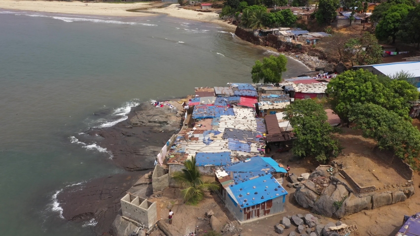 Aerial village rocky coast Freetown Sierra Leone. Poor fishing village on rocky Atlantic ocean shore. West Africa is a nation  suffers with extreme poverty and hunger. Tropical climate.