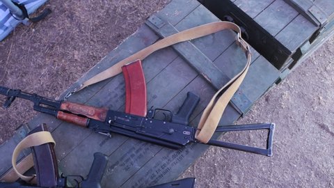 Kalashnikov assault rifles on military boxes.