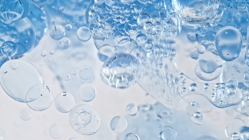 Macro Shot of Various Air Bubbles in Water Rising up on Light White Background. Liquid Cream Gel Transparent Cosmetic Sample Texture With Bubbles. Concept of Clean and Purity | Shutterstock HD Video #1070456098