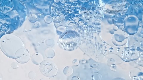 Macro Shot of Various Air Bubbles in Water Rising up on Light White Background. Liquid Cream Gel Transparent Cosmetic Sample Texture With Bubbles. Concept of Clean and Purity