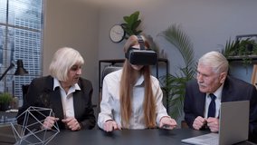 Businesswoman entrepreneur using VR app headset helmet doing research. Senior colleagues watching virtual reality 3D 360 video graph simulation at office. Busy freelancer working on modern tech device - Powered by Shutterstock - Get 15% off with code: PIKWIZARD15