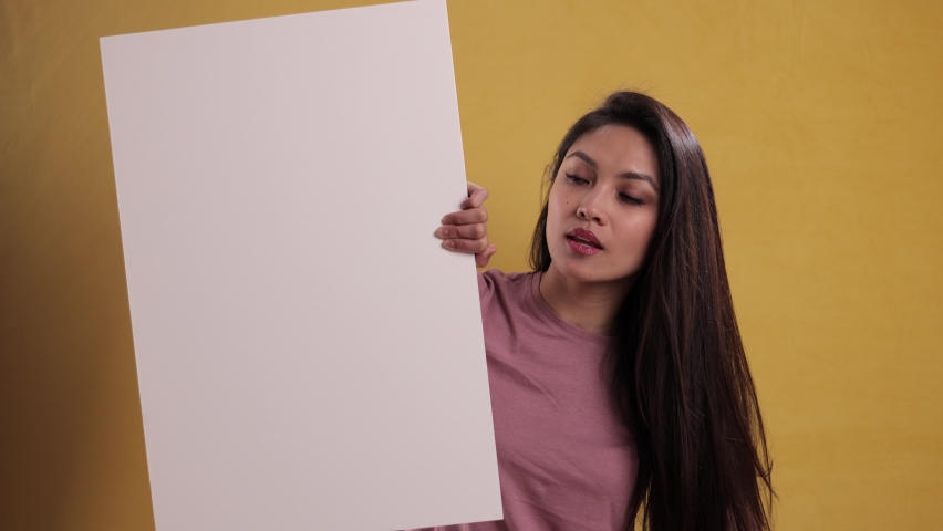 Young pretty woman holds a sign dummy - studio shooting