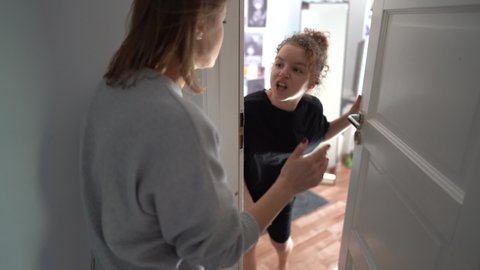 Mother knocks on the door of the daughters room. Internet addiction. Quarrel between mother and teenage daughter. Problems of the relationship between parents and children
