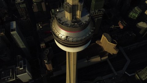 Toronto, Canada - 11 11 2020: 4K aerial flight starting from above CN tower bowl looking down then flying down and panning up camera to CN tower bowl while flying past and below bowl