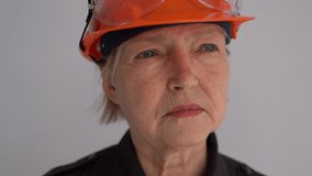 Close up portrait of a mature woman builder in a helmet. The profession is a civil engineer or an architect. Serious professional woman - Powered by Shutterstock - Get 15% off with code: PIKWIZARD15