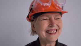 Portrait of a mature woman builder in a helmet. The profession is a civil engineer or an architect. Smiling professional woman - Powered by Shutterstock - Get 15% off with code: PIKWIZARD15