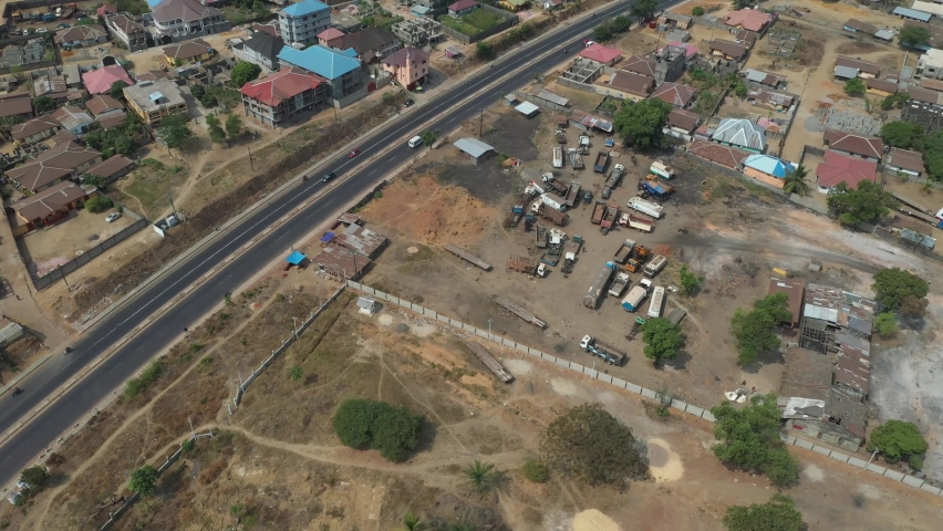 Aerial rural industrial area descent Freetown Sierra Leone. West Africa suffers with extreme poverty and hunger. Congested crowded roads and businesses. Tropical climate.