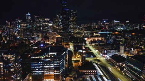 Downtown Seattle City Streets and Buildings at Night Aerial Hyperlapse. Nightlife drone motion tome lapse with cars driving downtown illuminated