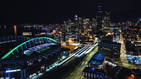 Seattle WA 2019 Aerial Hyperlapse Boomerang of Century Link Stadium at Night. Drone motion time lapse zooming in and out of professional sports arena