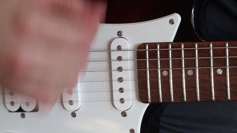 Musician playing electric guitar. Playing guitar close up. Hand plays guitar.
