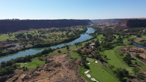 Aerial shot gliding over a golf course at the bottom of Snake River Canyon in Twin Falls, Idaho. 