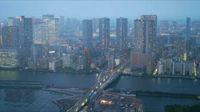 Tsukiji, Tsukiji Bridge, Sumida River, and skyscrapers seen from Shiodome, Tokyo. The sun is setting and the weather is changing from clear to thunder and back to clear. 4k time-lapse video. 