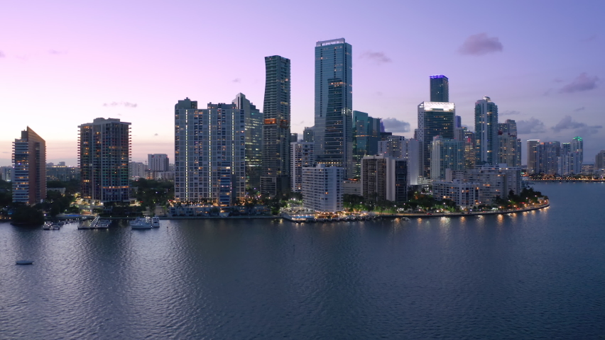 Downtown Miami at pink sunset. Scenic Miami skyline panorama. Aerial view of downtown at night scene. Beautiful urban landscape of coastal bay city at dusk. City lights in purple sunset light. Florida | Shutterstock HD Video #1070511229
