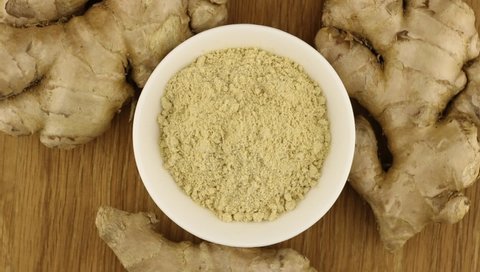 Ground ginger powder on the saucer and ginger roots rotates slowly.
