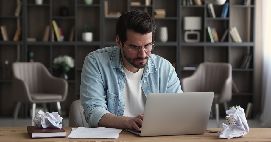 Anxious stressed young male manager employee entrepreneur in eyeglasses crumping paper documents, feeling nervous analyzing data statistics reports, standing and leaving workplace, deadline concept. Royalty-Free Stock Footage #1070517007