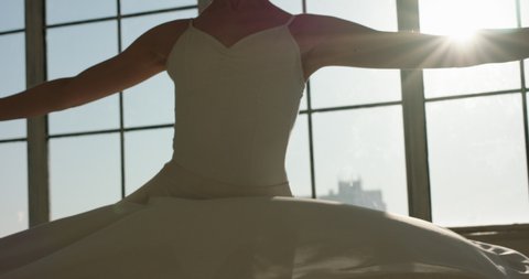 Ballerina girl in white dress is spinning, practicing dance moves. Choreograpgher on way to achieving goal - arts concept 4k footage