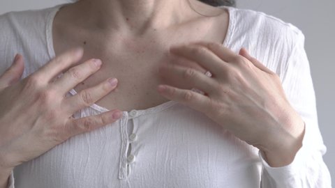 Woman practicing EFT - tapping on the collarbone point