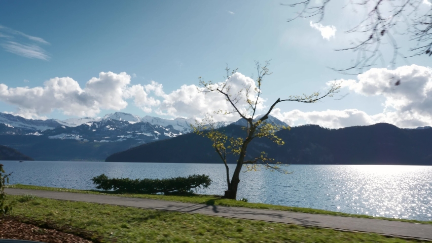 Mountain Lake Lucerne. Alps Switzerland Europe. View out of Car Moving on Highway Quay. Slow motion