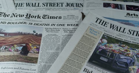 New York, New York  United States - March 24,  2021:Newspaper coverage of 18 people killed in one week in mass shootings in Atlanta and Colorado.
