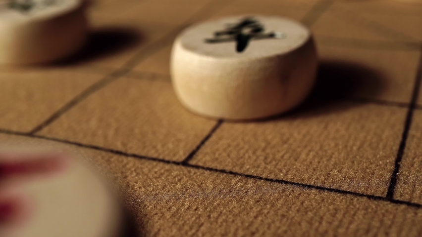 Close-up of moving a pawn on chessboard by hand, Chinese chess, picture text "pawn"