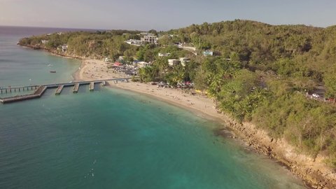 Aerial View of Crash Boat Beach, Borinquen, Aguadilla, Puerto Rico. Scenic Coast and Vegetation by Caribbean Sea on Sunny Day, Drone Shot