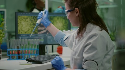 Biologist researcher using micropipette and petri dish to discovering gmo solution. Scientist chemist woman analyzing medical expertise working in pharmaceutical laboratory