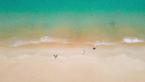 4K Top-view in drone shot. Video of beach sea. Beautiful sea waves. Beach sand and amazing sea. Summer sunset seascape. Phuket Thailand Beach. Water texture. Top view of the fantastic natural sunsets