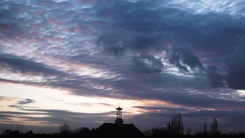 altocumulus navy blue cloud forming sunset sky time lapse silhouette clock tower