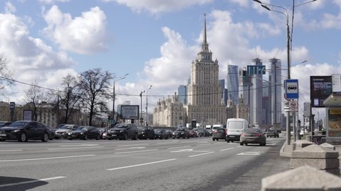 Moscow Russia-April 2021:The traffic of cars along Novy Arbat street towards the Novoarbatsky bridge. In the background - the building of the Radisson Hotel and the skyscrapers of Moscow City.