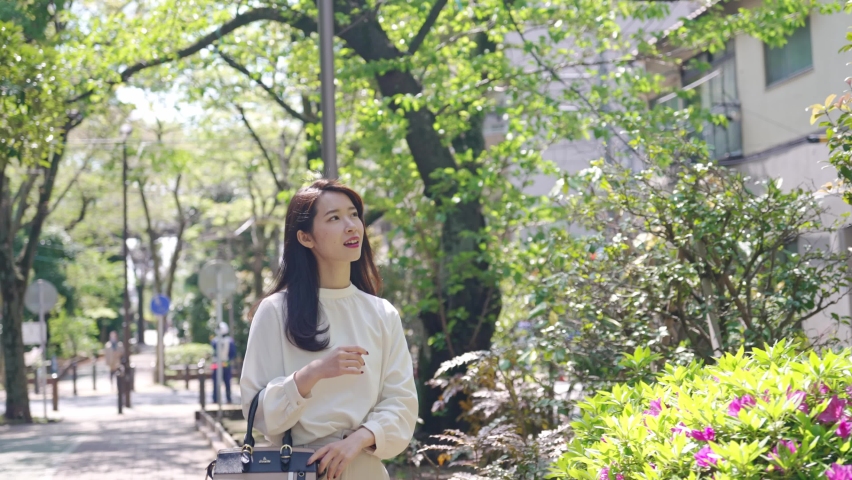Young asian woman walking in the town. Royalty-Free Stock Footage #1070551531