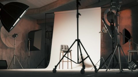 Empty photo studio with chair. Professional photo studio with lights on. 3d visualization