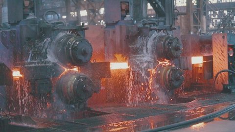 Metal production process in a metallurgical factory slow motion. Modern metallurgical factory. Red hot metal in a modern factory.